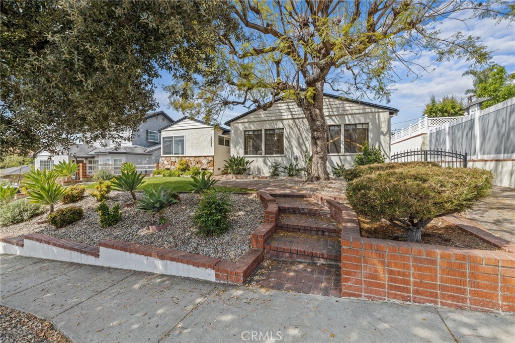 3045 Scott Road Burbank, CA 91504 - Photo 2 of 39 a front view of a house with garden