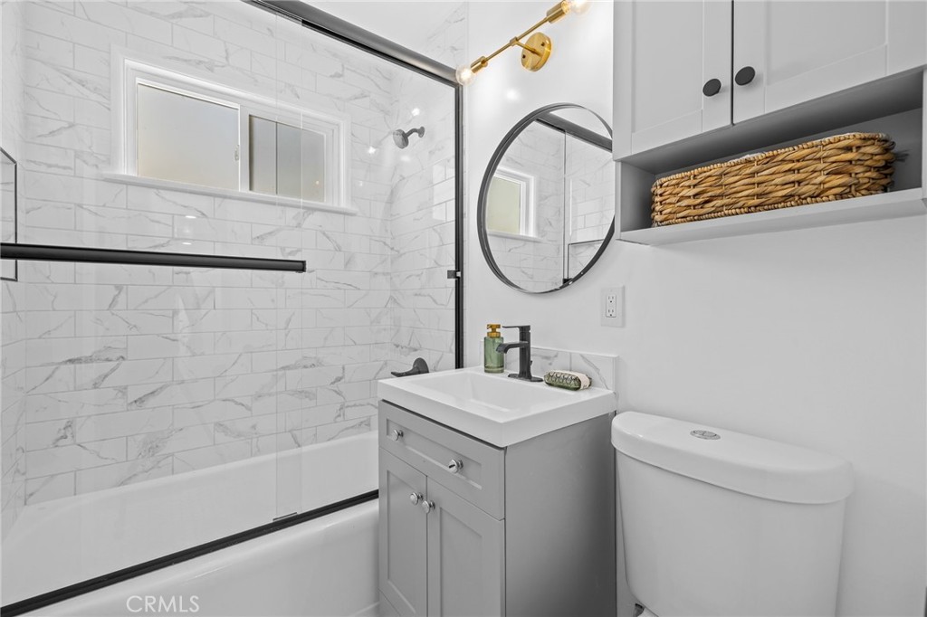 3045 Scott Road Burbank, CA 91504 - Photo 23 of 39 a bathroom with a sink a toilet and a mirror