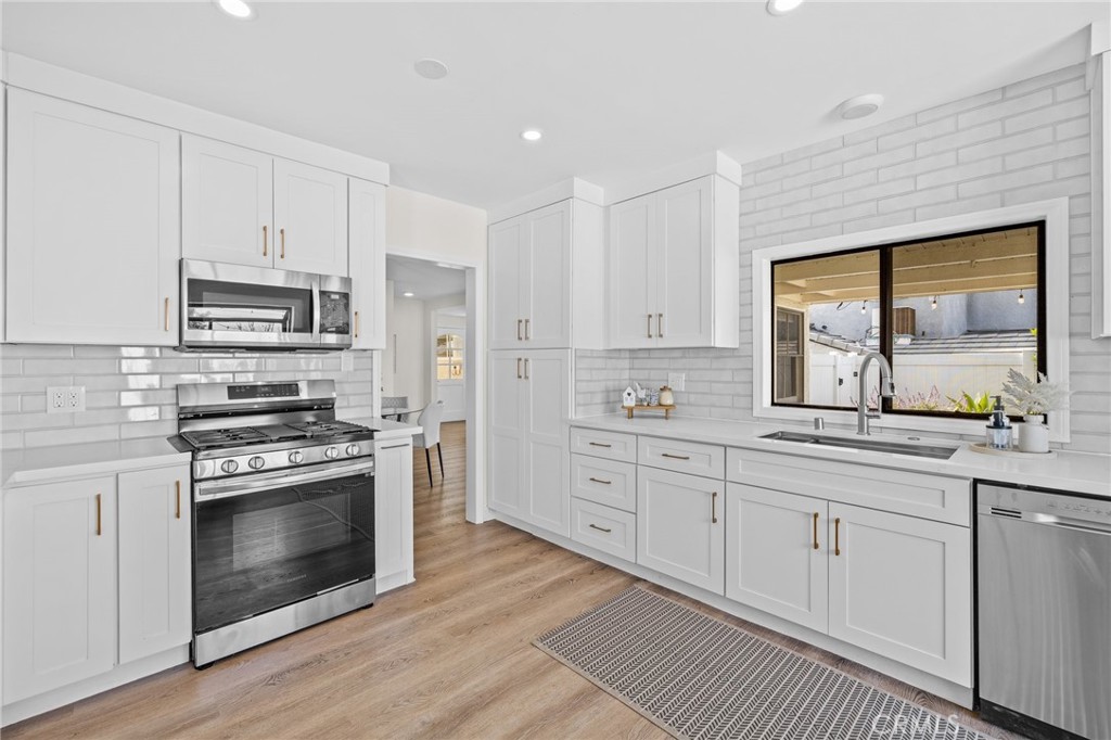 3045 Scott Road Burbank, CA 91504 - Photo 10 of 39 a kitchen with granite countertop white cabinets stainless steel appliances and a window