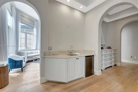 a bathroom with a double vanity sink a mirror and a bathtub