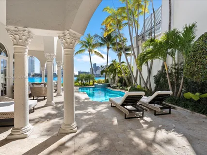 a view of a patio with a table and chairs under an umbrella