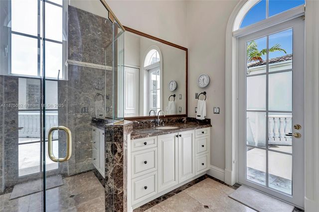 a bathroom with a granite countertop sink a toilet and shower