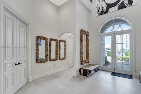 a view of a hallway with entryway wooden floor and front door