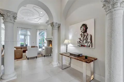 a living room with furniture kitchen view and large windows