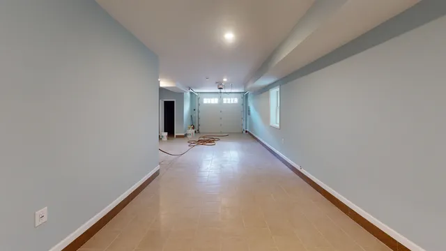 wooden floor in a hall with a window