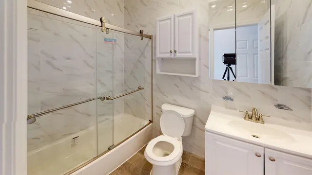a bathroom with a toilet a sink and a shower
