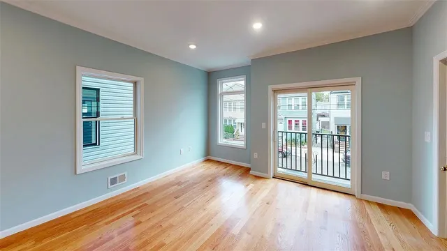 a view of a room with wooden floor and a window