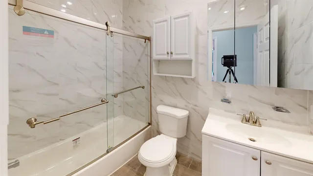 a bathroom with a sink toilet and shower