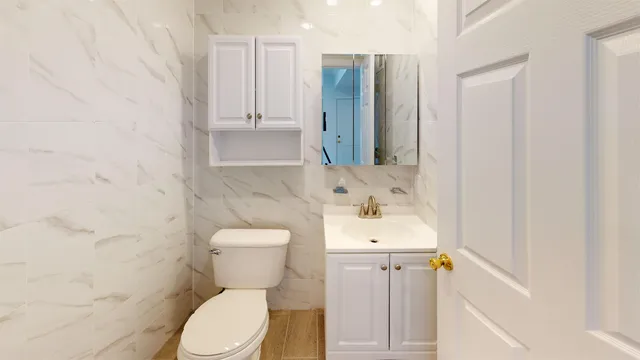 a bathroom with a sink toilet and shower