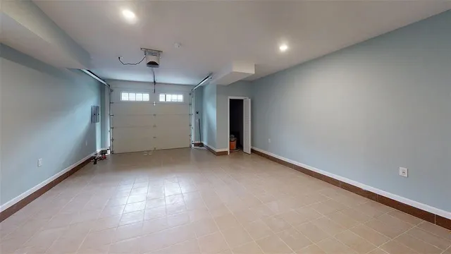 an empty room with stairs and wooden shelves