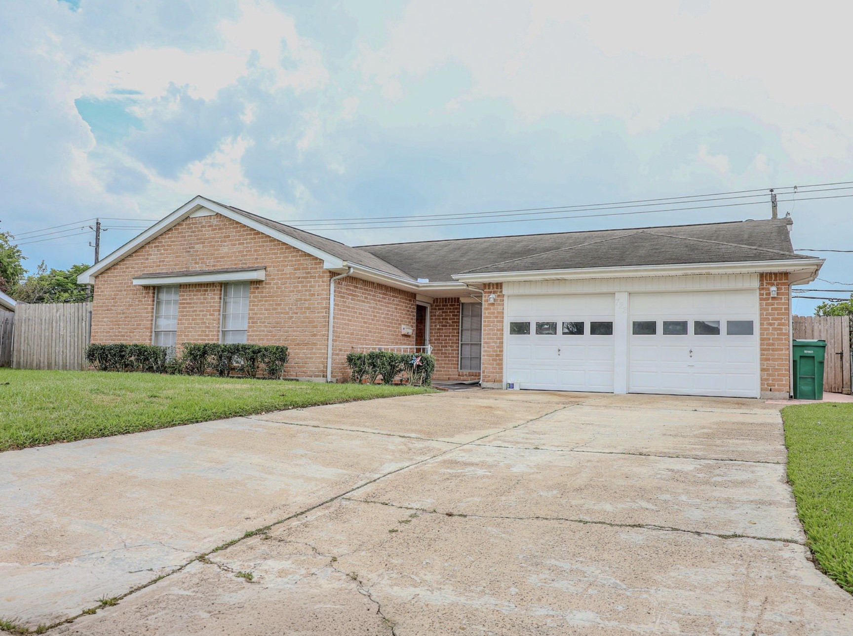 a front door view of a house with a yard and garage