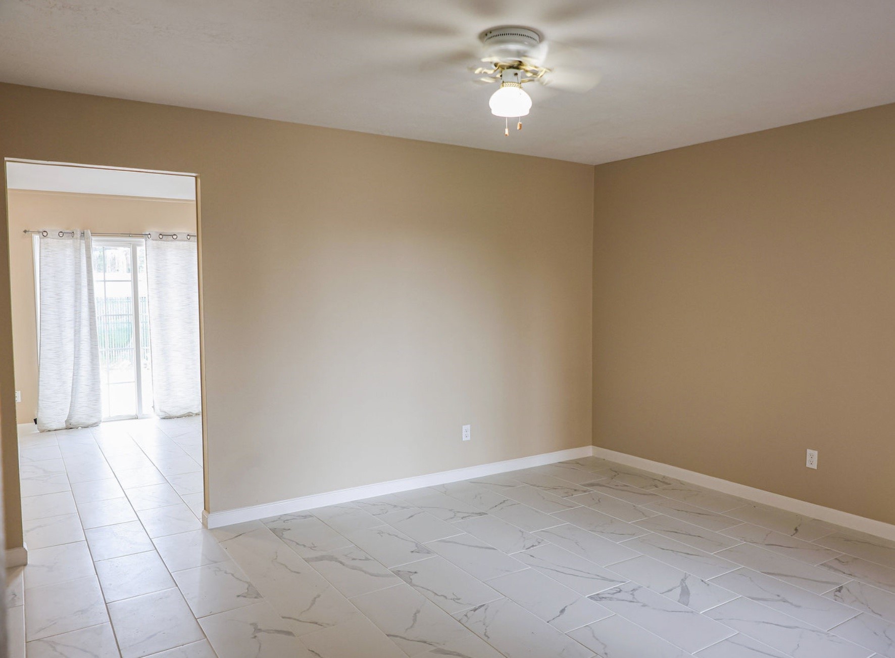 722 Canna Street Channelview, TX 77530 - Photo 2 of 10 an empty room with a empty space and a ceiling fan