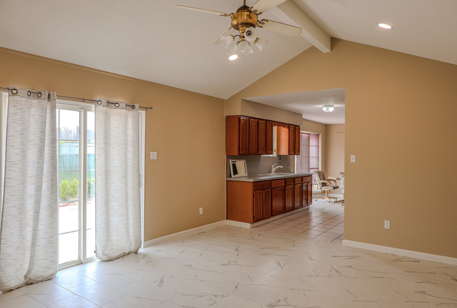 722 Canna Street Channelview, TX 77530 - Photo 3 of 10 a open kitchen with kitchen island a stove a refrigerator a sink and dishwasher with wooden floor