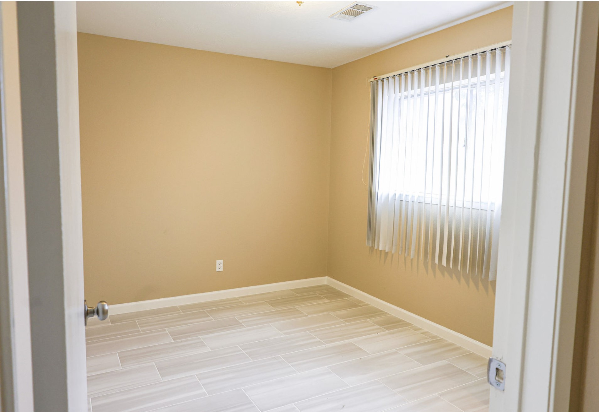 722 Canna Street Channelview, TX 77530 - Photo 8 of 10 a view of an empty room with wooden floor and a window