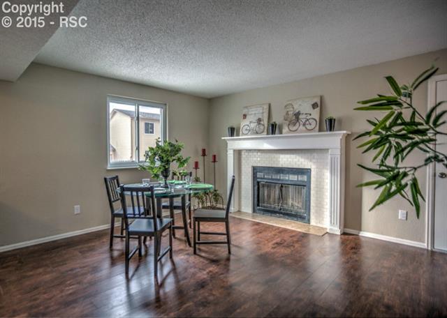 1730 Doherty Road Colorado Springs, CO 80916 - Photo 6 of 32 Beautiful flooring in the dining area with cozy fireplace