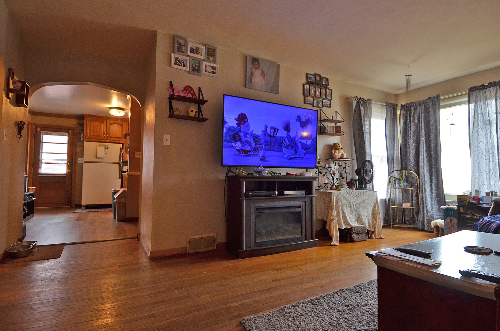 772 Adams Street Ottawa, IL 61350 - Photo 3 of 15 a living room with furniture a flat screen tv and a fireplace