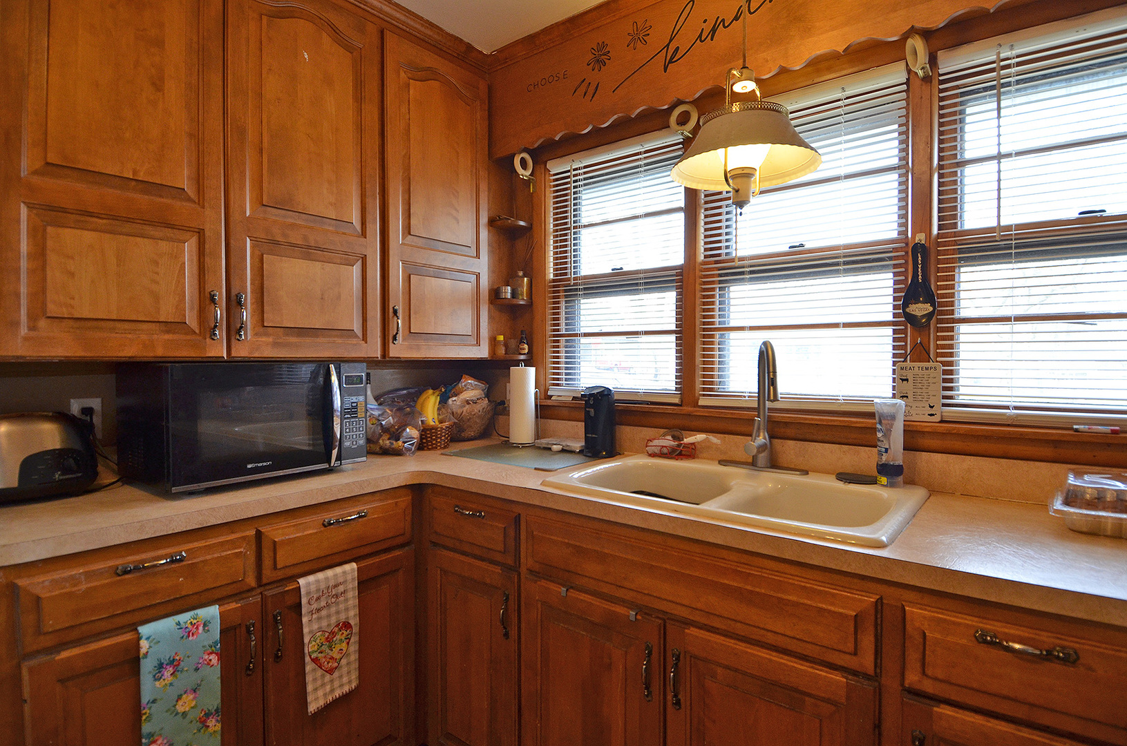 772 Adams Street Ottawa, IL 61350 - Photo 8 of 15 a kitchen with stainless steel appliances granite countertop a sink a microwave cabinets and a window