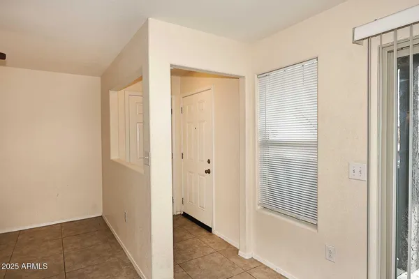 an empty room with windows and fireplace