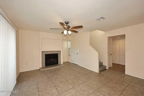 a view of an empty room with a fireplace
