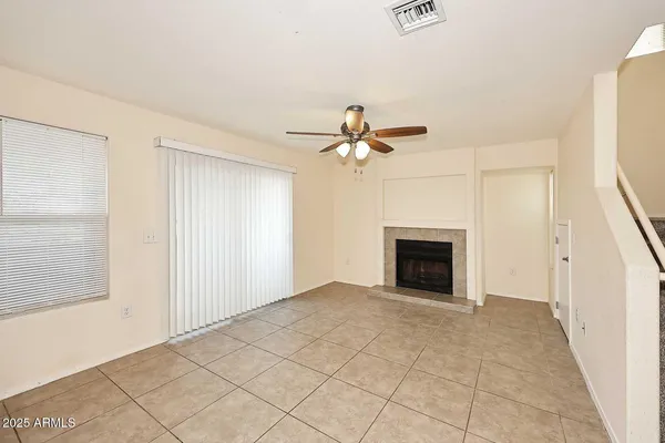 a view of a livingroom with a ceiling fan and a rug