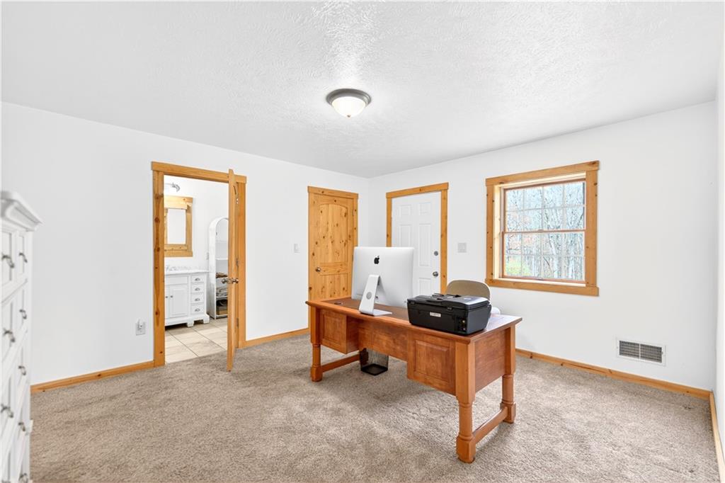 199 Lower Harmony Road Prospect, PA 16052 - Photo 22 of 49 First floor 2 room primary suite! This room is used as home office. It has direct access to a deck and laundry.