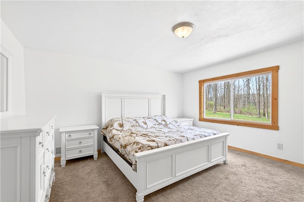 199 Lower Harmony Road Prospect, PA 16052 - Photo 25 of 49 First floor primary bedroom. Large windows with beautiful views.