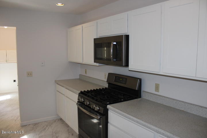 399 River Road Windsor, MA 01270 - Photo 4 of 19 a kitchen with granite countertop cabinets and steel stainless steel appliances