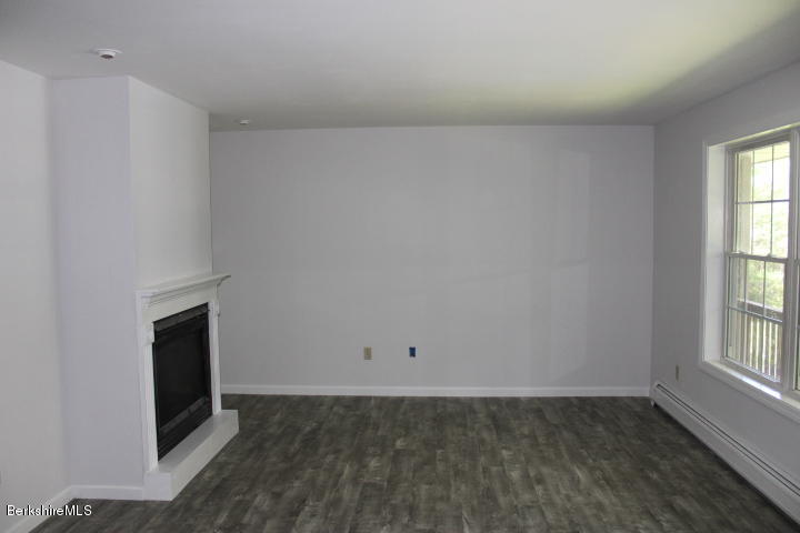399 River Road Windsor, MA 01270 - Photo 5 of 19 an empty room with windows