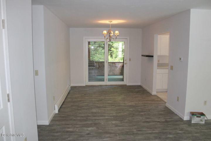 399 River Road Windsor, MA 01270 - Photo 8 of 19 a view of an empty room with wooden floor and a window