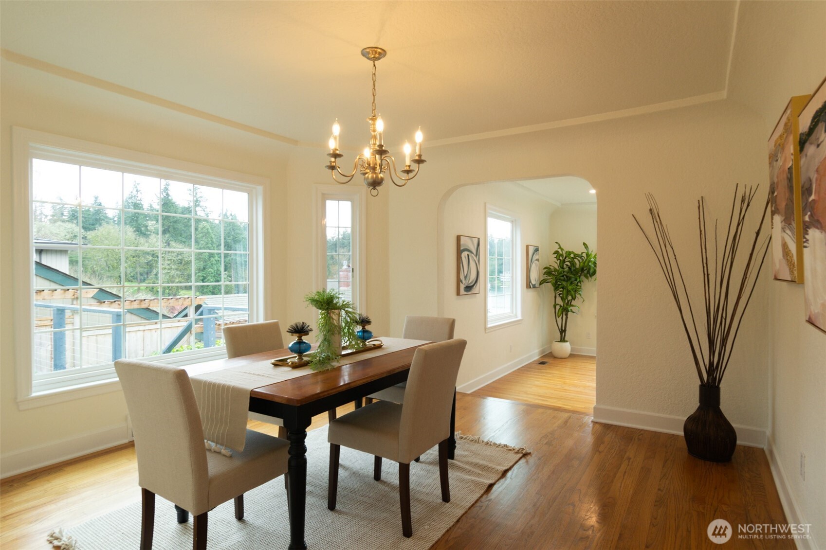10826 Meadow Road Southwest Lakewood, WA 98499 - Photo 12 of 40 a view of a dining room with furniture wooden floor and a chandelier