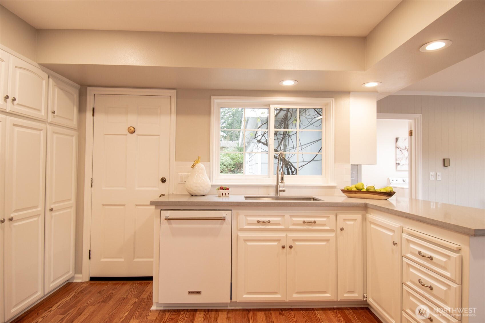 10826 Meadow Road Southwest Lakewood, WA 98499 - Photo 14 of 40 a kitchen with stainless steel appliances granite countertop a sink and cabinets with wooden floor