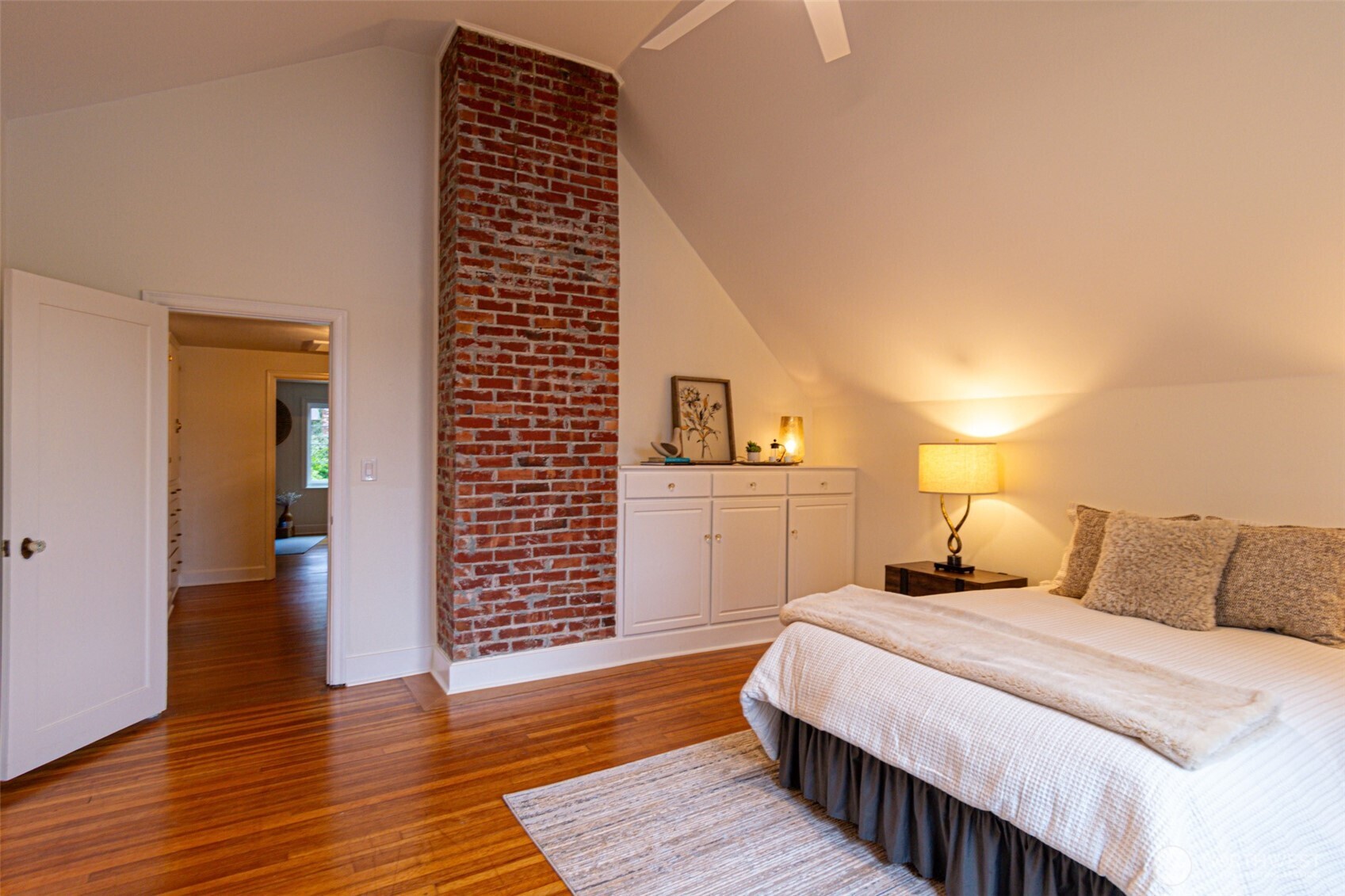 10826 Meadow Road Southwest Lakewood, WA 98499 - Photo 19 of 40 a bedroom with a bed and wooden floor