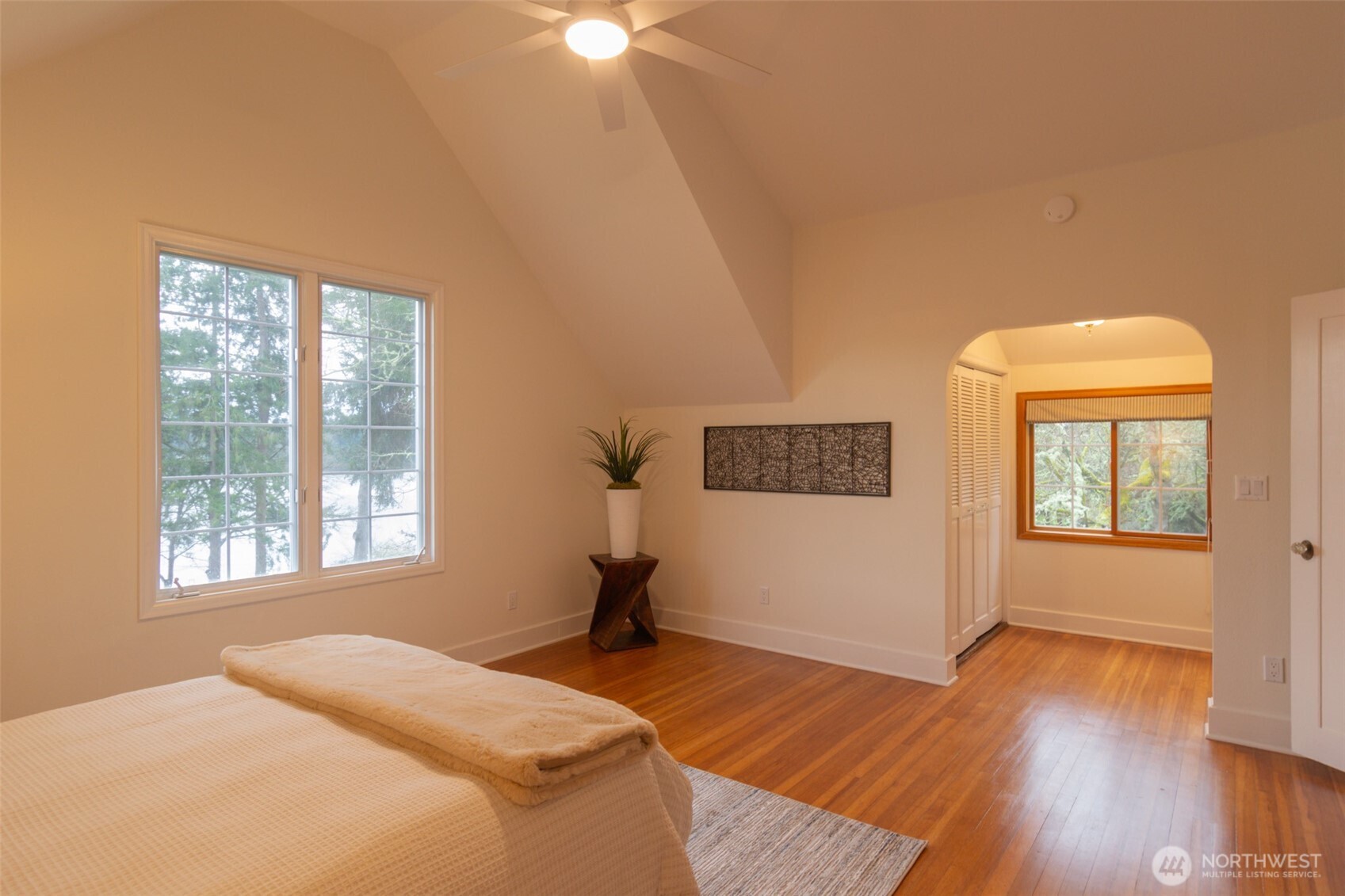10826 Meadow Road Southwest Lakewood, WA 98499 - Photo 20 of 40 a bedroom with a bed and wooden floor