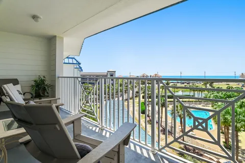 a view of a chairs and table in the balcony