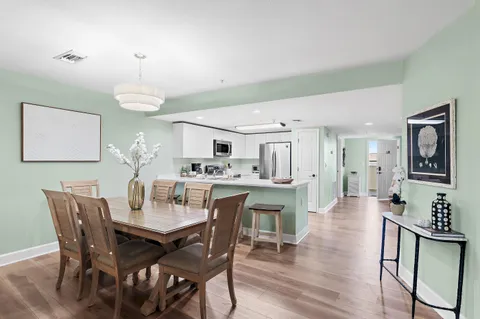 a view of a dining room with furniture and wooden floor