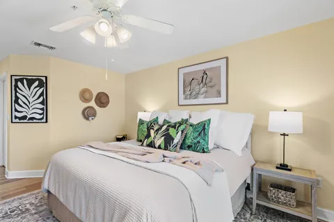 a bedroom with a bed and a lamp on dresser