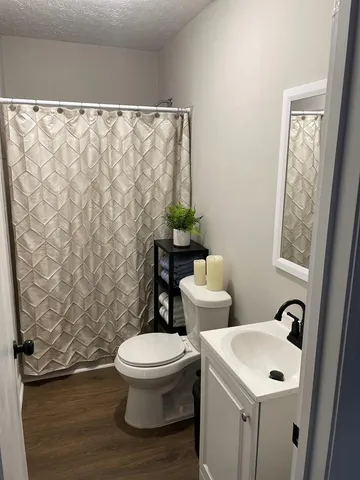 a white toilet sitting next to a bathroom sink