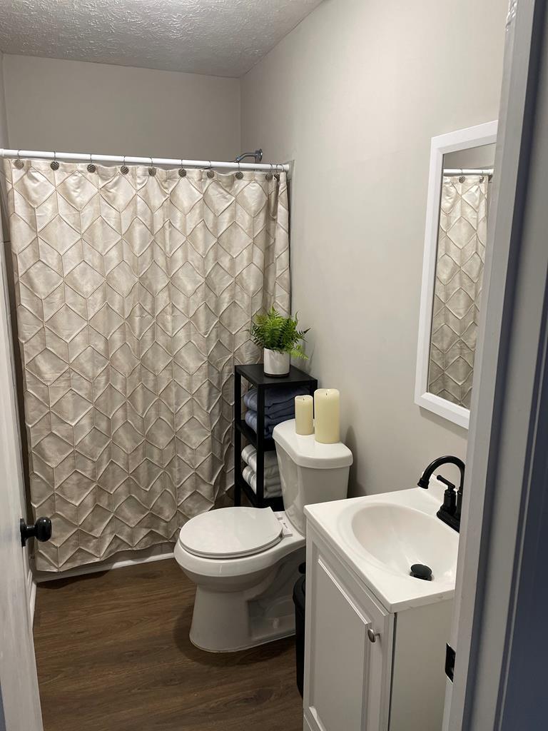 2001 Hamilton Road, Unit 1 Columbus, GA 31904 - Photo 4 of 4 a white toilet sitting next to a bathroom sink