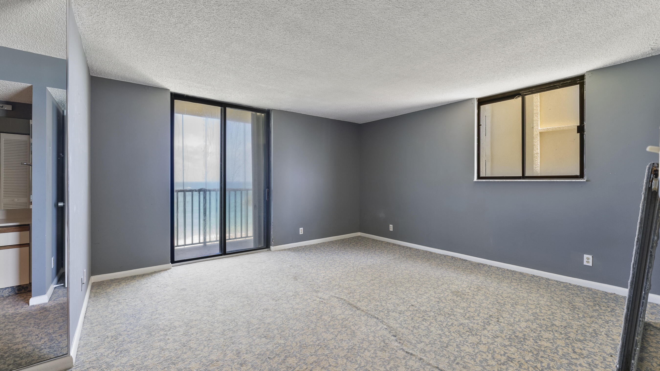 300 Ocean Trail Way, Unit 401 Jupiter, FL 33477 - Photo 15 of 41 an empty room with windows and closet