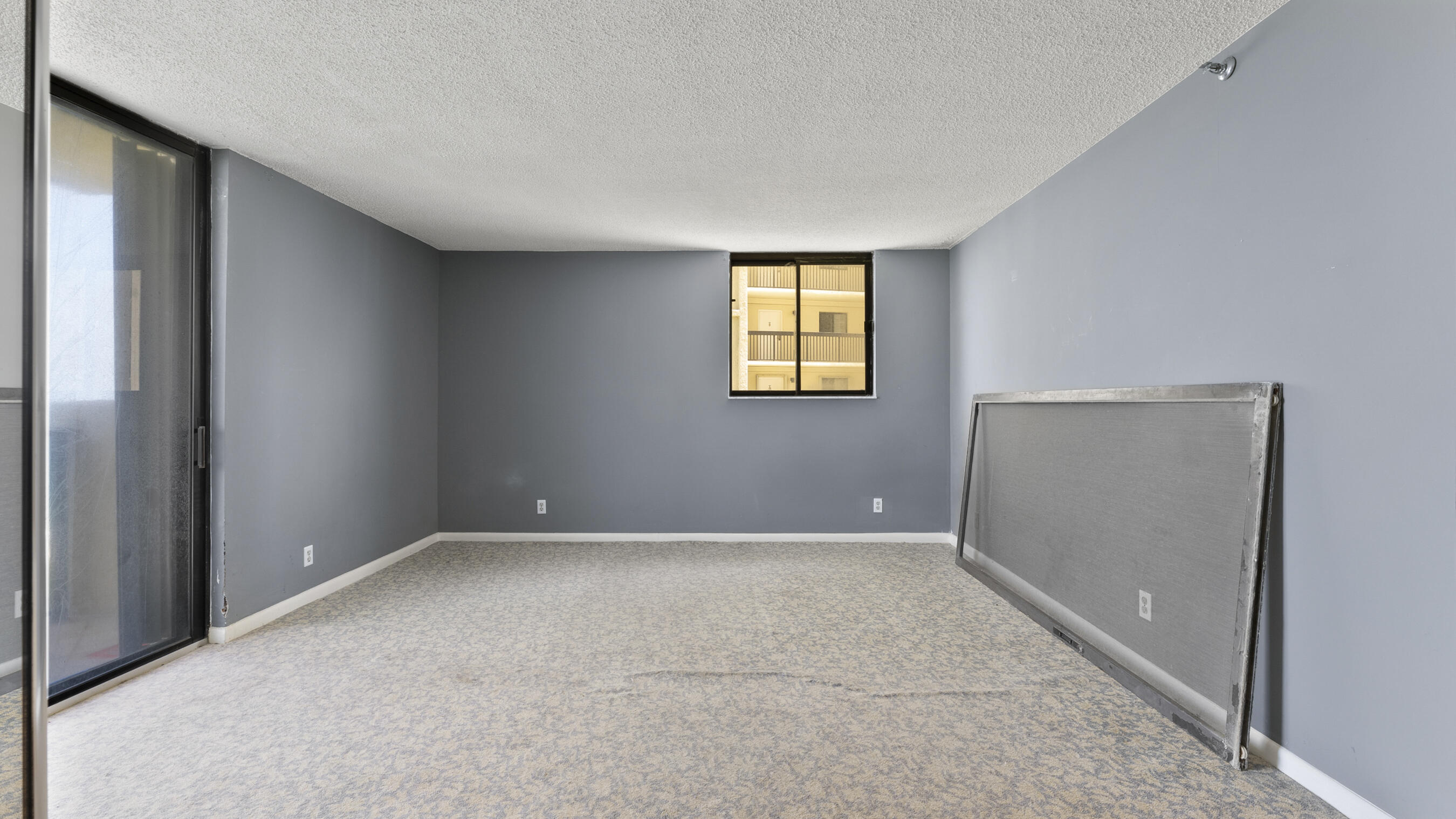 300 Ocean Trail Way, Unit 401 Jupiter, FL 33477 - Photo 16 of 41 an empty room with windows and closet