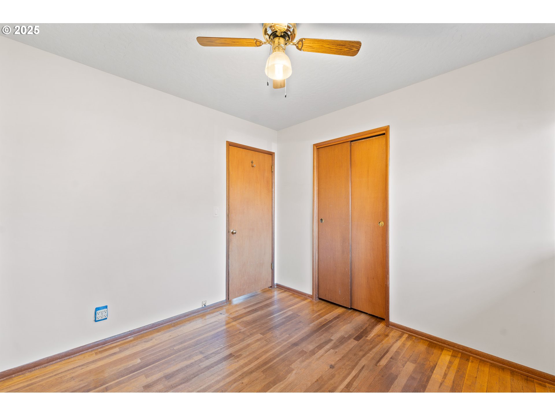 12342 Northeast Knott Street Portland, OR 97230 - Photo 11 of 40 a view of an empty room with window and wooden floor
