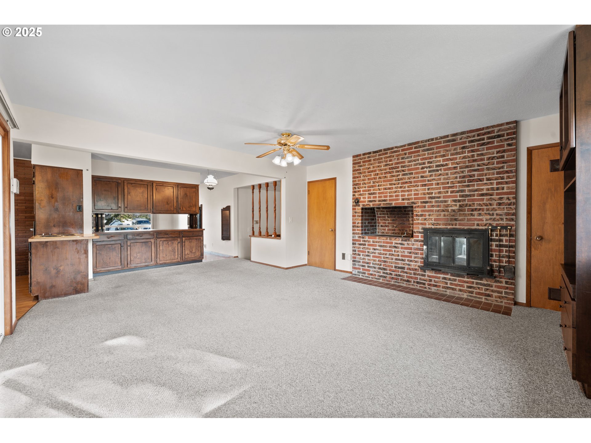 12342 Northeast Knott Street Portland, OR 97230 - Photo 18 of 40 a view of a livingroom with an empty space and a fireplace