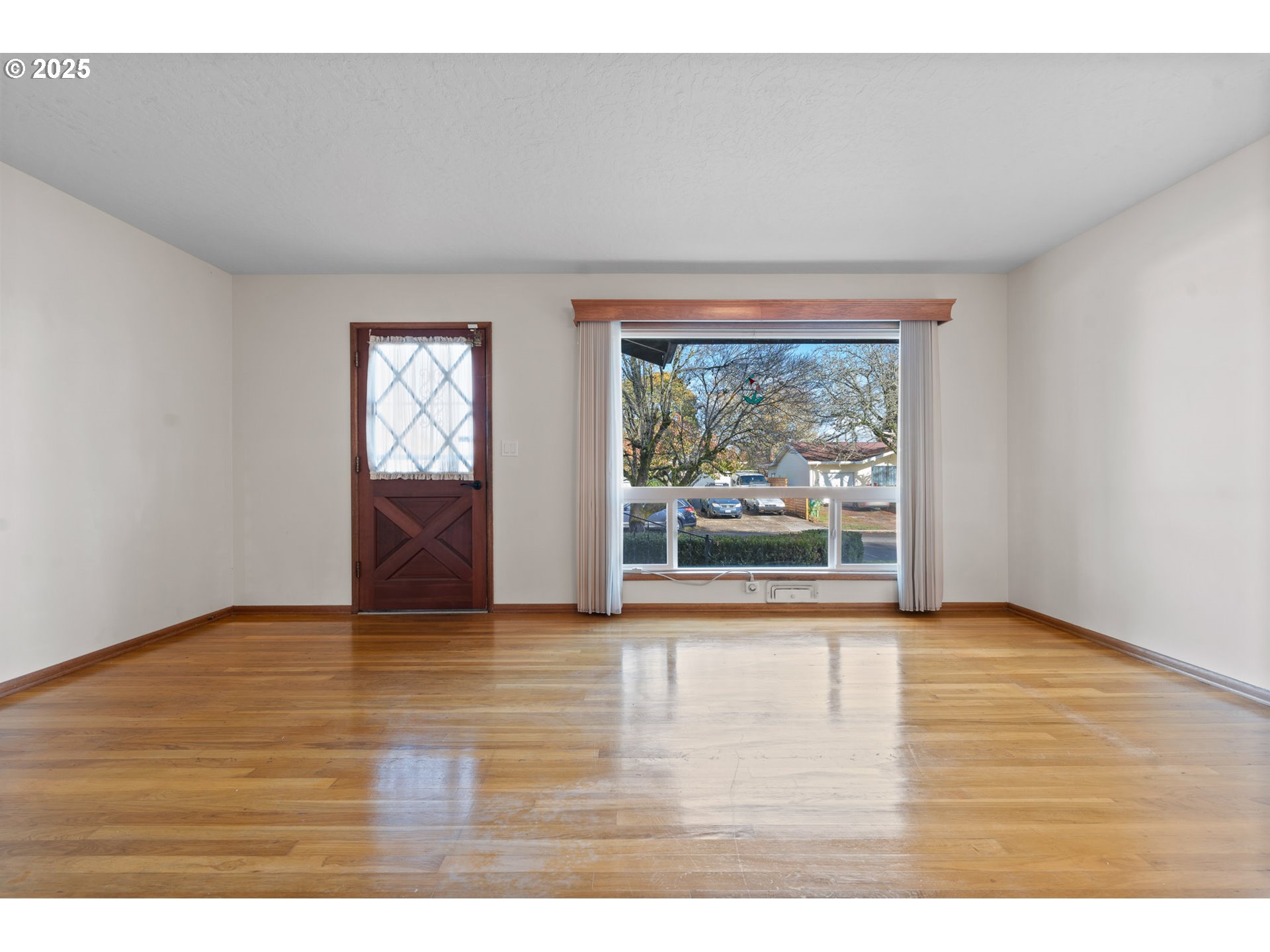 12342 Northeast Knott Street Portland, OR 97230 - Photo 5 of 40 a view of empty room with wooden floor and fan
