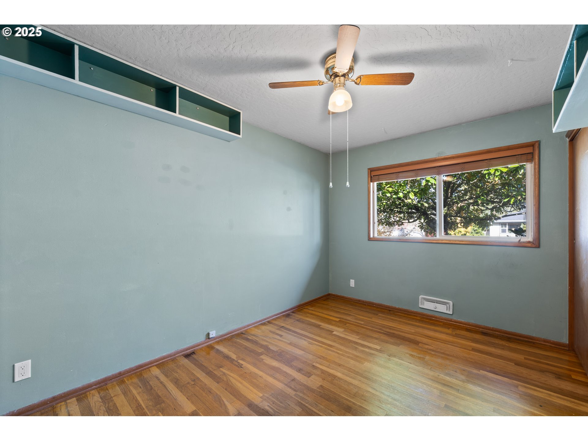 12342 Northeast Knott Street Portland, OR 97230 - Photo 10 of 40 an empty room with wooden floor fan and windows