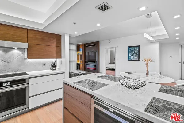 a kitchen with sink and refrigerator