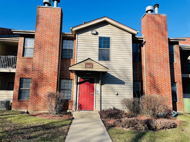1915 North Hicks Road, Unit 106 Palatine, IL 60074 - Photo 1 of 11 a front view of a house with a yard