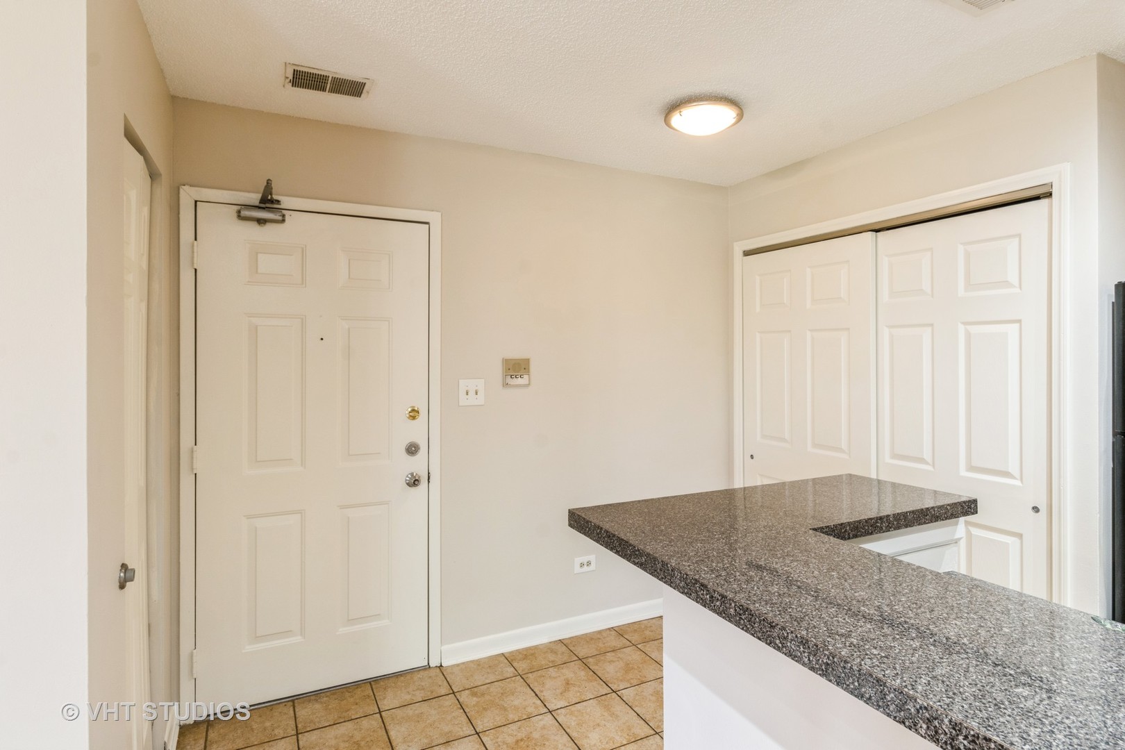 1915 North Hicks Road, Unit 106 Palatine, IL 60074 - Photo 3 of 11 a bathroom with a granite countertop sink and shower