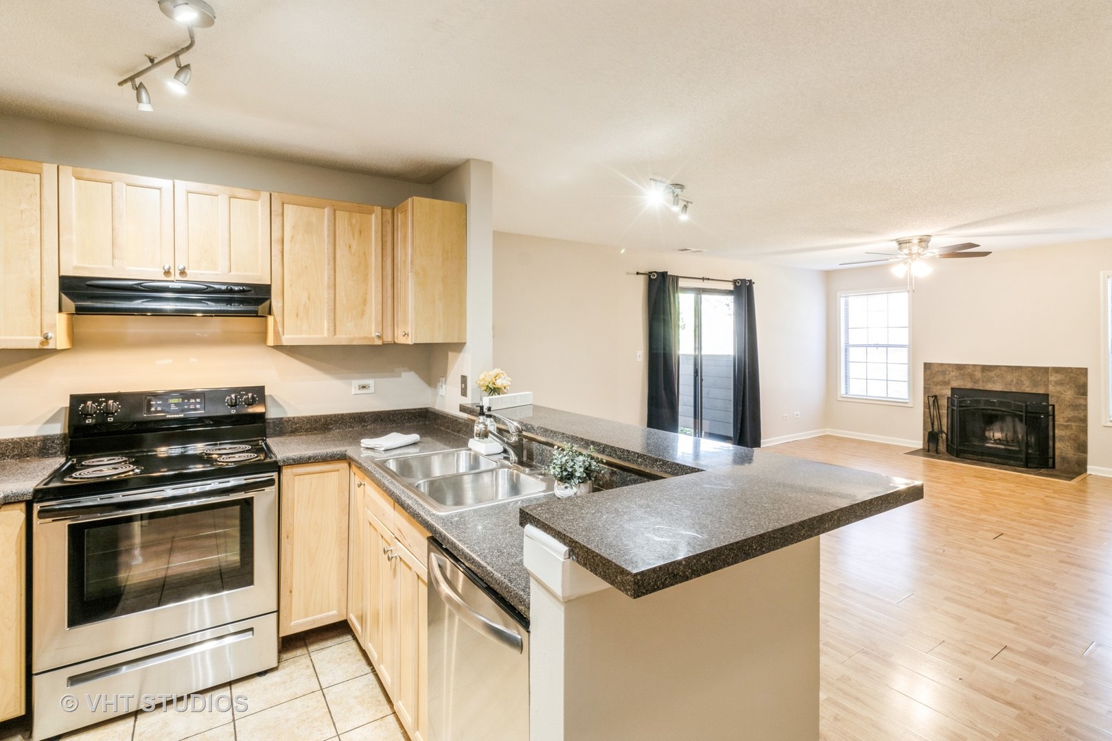 1915 North Hicks Road, Unit 106 Palatine, IL 60074 - Photo 5 of 11 a kitchen with granite countertop a sink stove and cabinets
