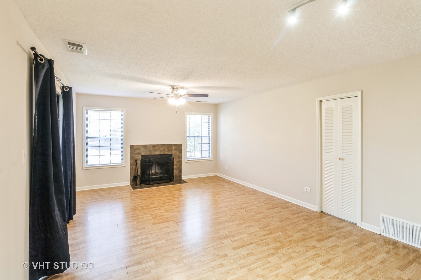 1915 North Hicks Road, Unit 106 Palatine, IL 60074 - Photo 6 of 11 a view of a livingroom with wooden floor and a fireplace