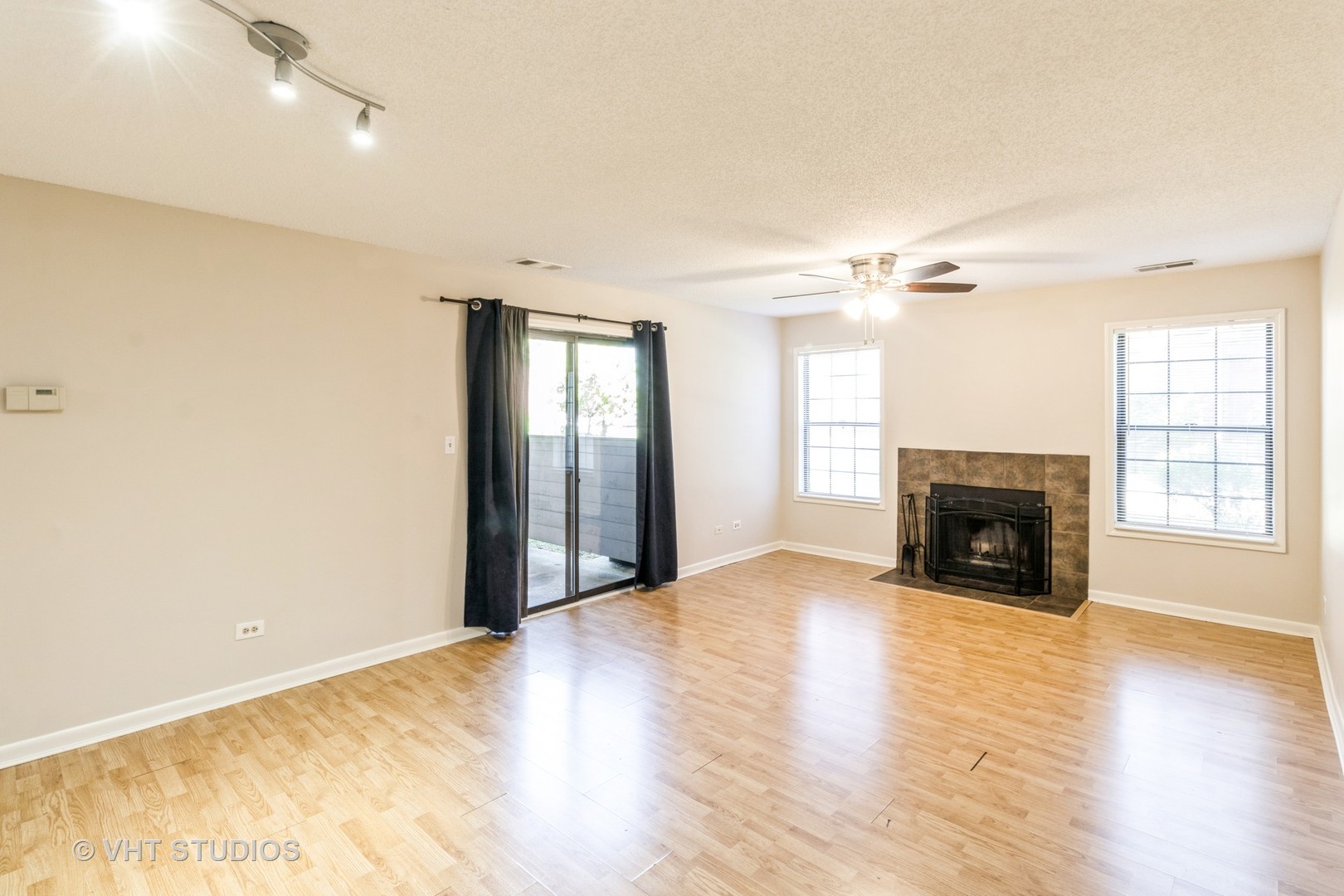 1915 North Hicks Road, Unit 106 Palatine, IL 60074 - Photo 7 of 11 a view of an empty room with window and fire place